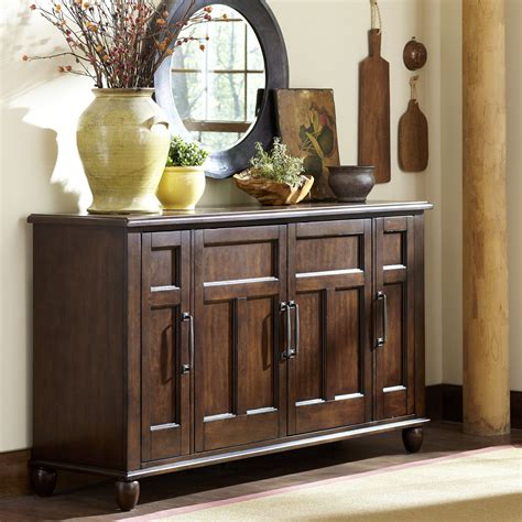 Four paneled cabinets with magnetic catches open to reveal adjustable shelf space. . Wayfair sideboard